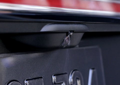 The rear camera wash is shown spraying the camera lens to clean it.