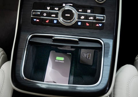 A smartphone is shown being charged on an available wireless charging pad.