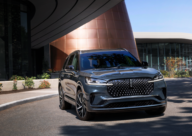 A gray 2025 Lincoln Aviator® SUV is parked outside a modern building with the sun shining. | Astro Lincoln in Pensacola FL