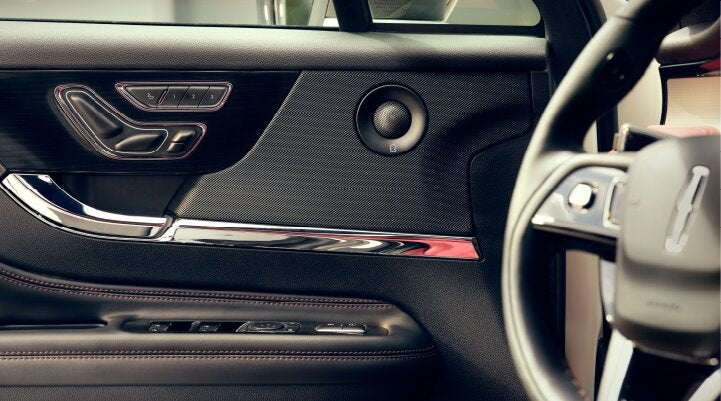 A Revel® audio speaker is shown in the driver's side door of a 2025 Lincoln Corsair® SUV. | Astro Lincoln in Pensacola FL