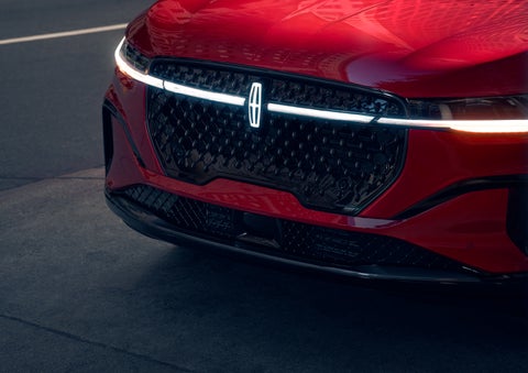 The available front LED light bar and center Lincoln Star logo glow at dusk. | Astro Lincoln in Pensacola FL