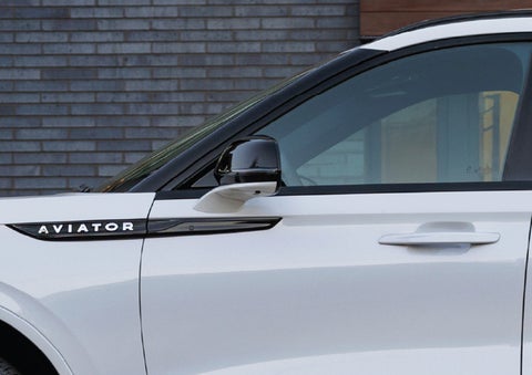 The driver’s side door and fender badging of a white 2026 Lincoln Aviator® SUV are showcased. | Astro Lincoln in Pensacola FL