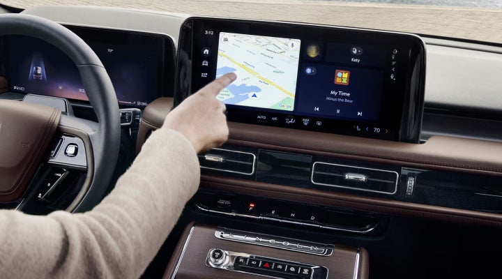 A person is tapping the center display touchscreen of a 2026 Lincoln Aviator® SUV. | Astro Lincoln in Pensacola FL