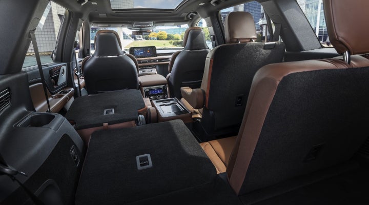 One side of the PowerFold® third-row seat and a second-row seat are folded forward in the 2026 Lincoln Aviator® SUV. | Astro Lincoln in Pensacola FL