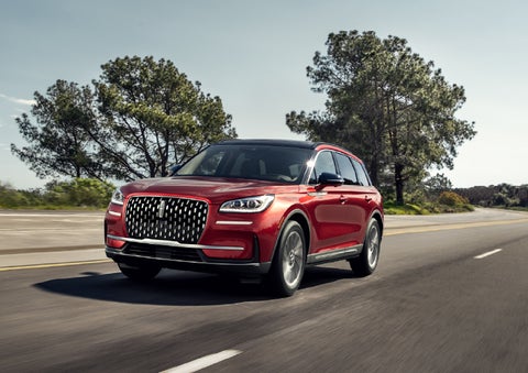 A 2026 Lincoln Corsair® SUV is shown being driven on a country road. | Astro Lincoln in Pensacola FL