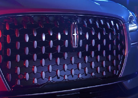 The grille of a 2025 Lincoln Corsair&reg; SUV reflects neon light at night. | Astro Lincoln in Pensacola FL