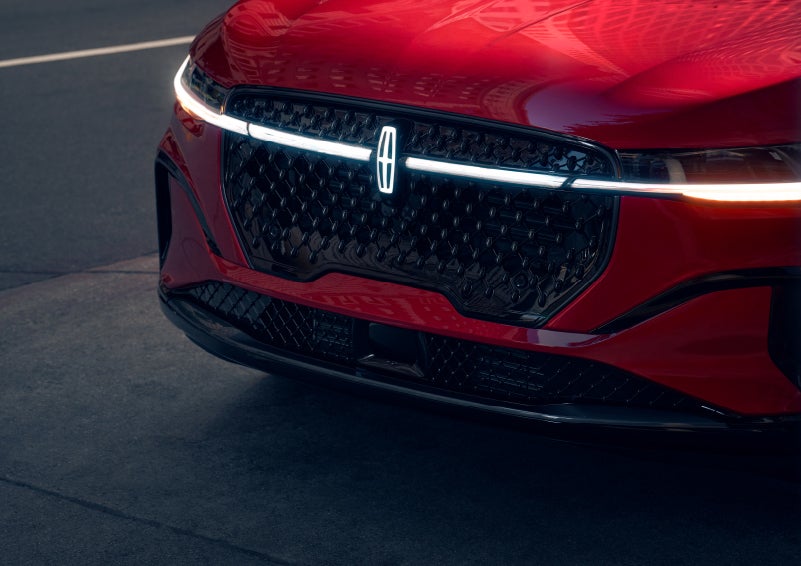 The available front LED light bar and center Lincoln Star logo glow at dusk. | Astro Lincoln in Pensacola FL