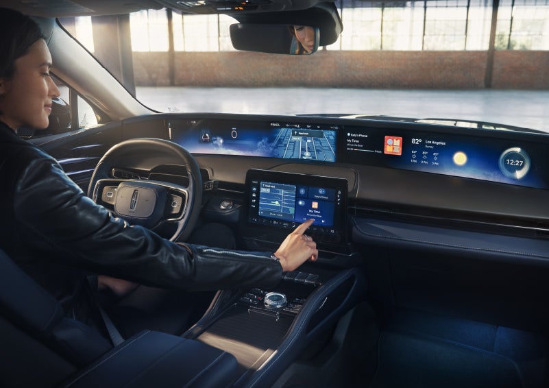 The driver of a 2026 Lincoln Nautilus® SUV interacts with the center touchscreen. | Astro Lincoln in Pensacola FL