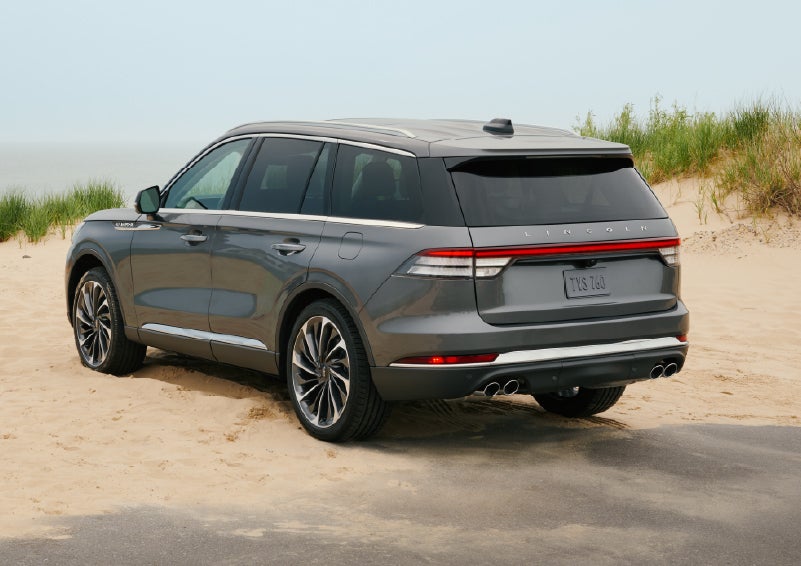 A 2027 Lincoln Aviator® SUV is parked next to sand dunes. | Astro Lincoln in Pensacola FL