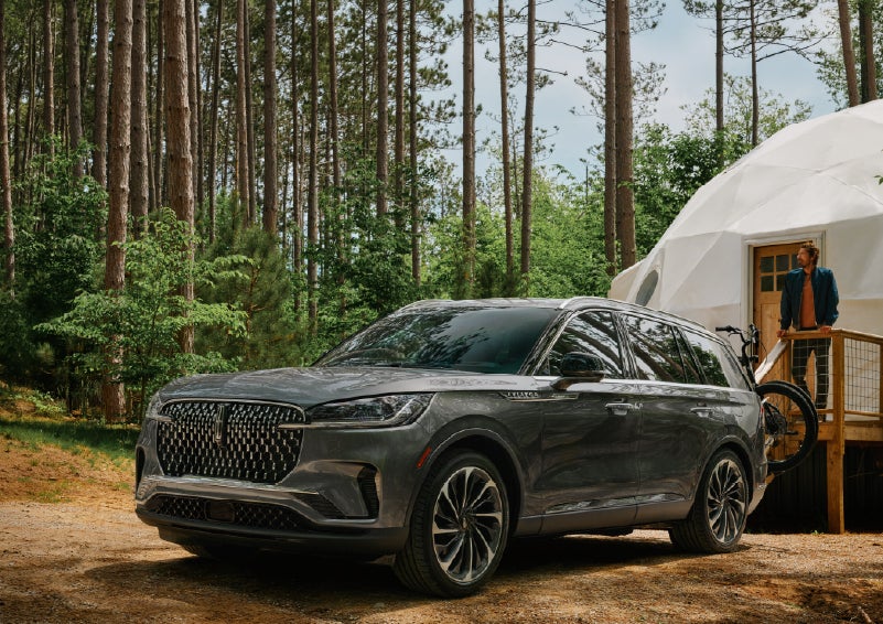A 2027 Lincoln Aviator® is parked next to a high end glamping site. | Astro Lincoln in Pensacola FL