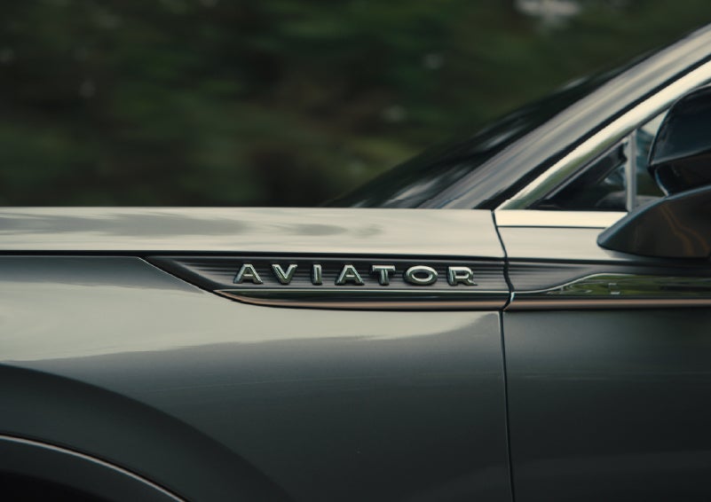 The driver’s side door and fender badging of a gray 2027 Lincoln Aviator® SUV are showcased. | Astro Lincoln in Pensacola FL