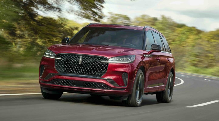 A 2027 Lincoln Aviator® SUV is being driven on a country road | Astro Lincoln in Pensacola FL