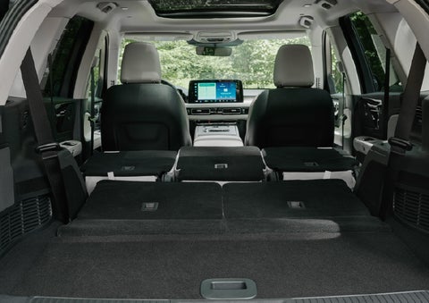 A rear to front view of the interior of a 2027 Lincoln Aviator® Black Label™ SUV shows the third and second rows folded flat | Astro Lincoln in Pensacola FL